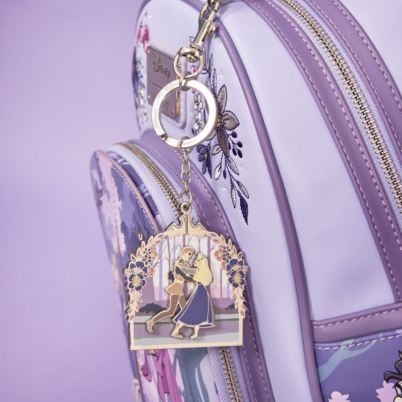 Image of the Loungefly Disney Sleeping Beauty 65th Anniversary Floral Scene Sliding Keychain attached to the 65th Anniversary Mini Backpack 